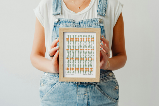 Person holding a framed artwork with a white background
